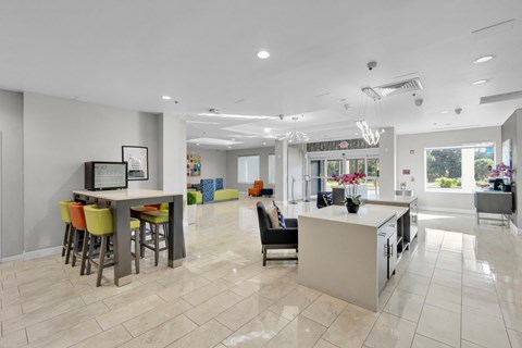 a kitchen and living room with a bar and chairs and a table